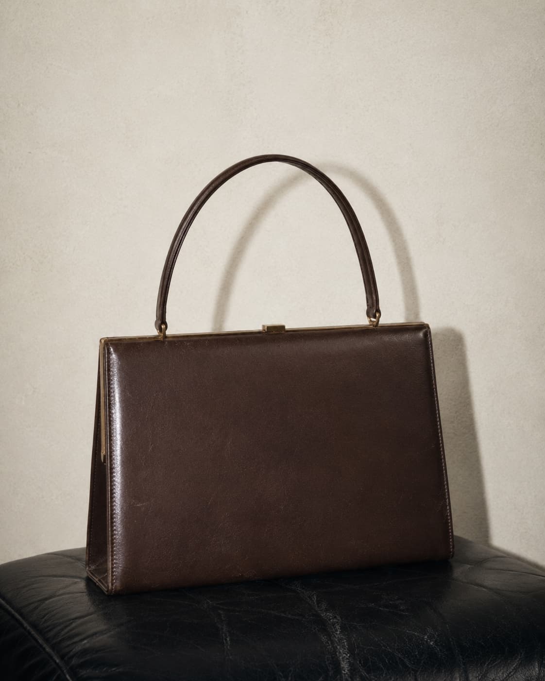 Brown handbag on a neutral background.